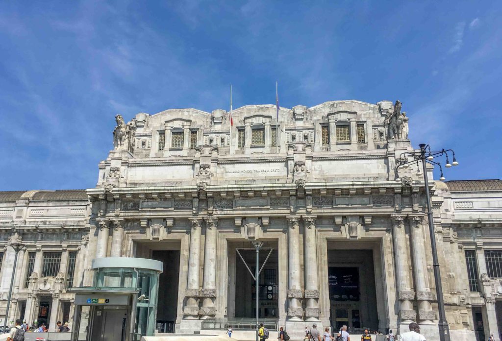Milano Train Station with Blue Sky showing the Brutalist architecture. Arriving by train is a great choice to spend one day in Milan.
