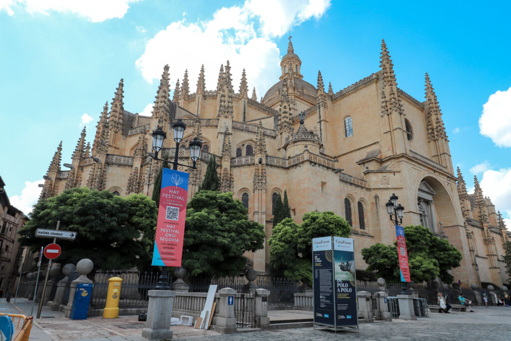 The many small spires of the Segovia Cathedral against a blue sky