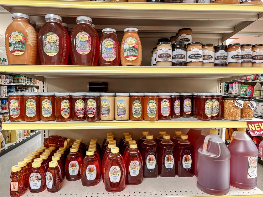 Golden honey in various shades fills a grocery store shelf in Lancaster, Co PA