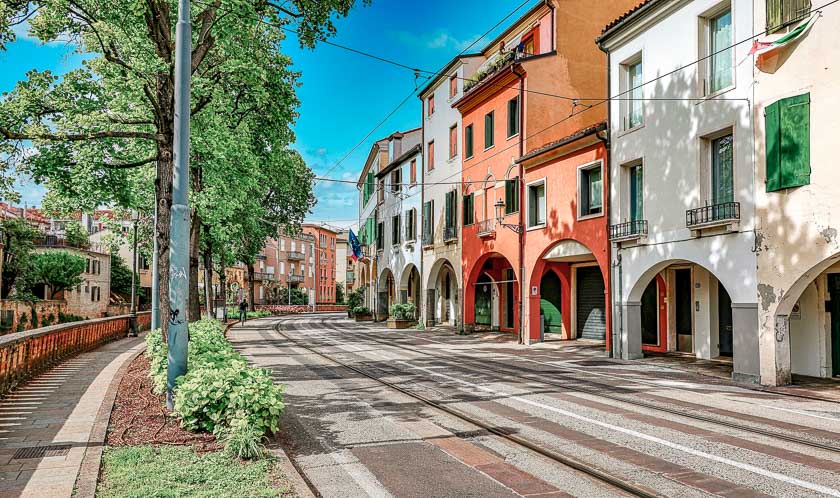 A street with terracotta houses and the tram lines in Padua Italy